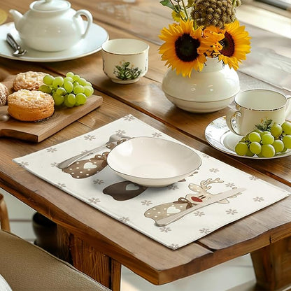 Beige reindeer snowflake placemat on dining table with cups, plates, and teapot