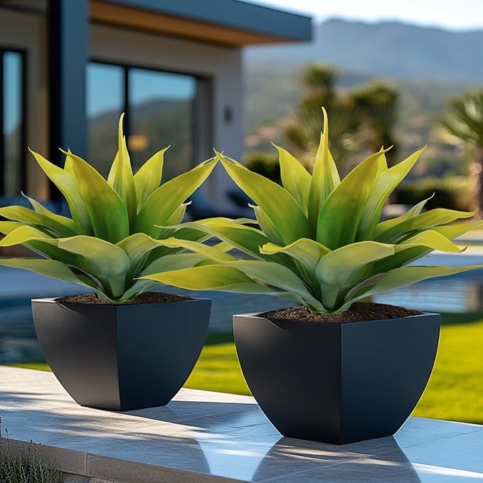 Faux agave plants with yellow-green leaves, two in dark square planters outdoors