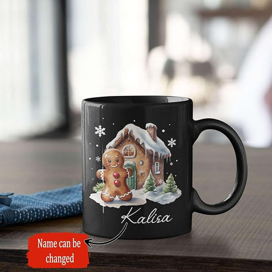 Black ceramic mug with gingerbread house design, “Kalisa” name on front.