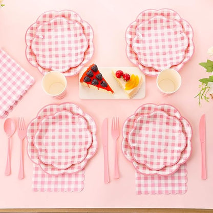 Pink gingham picnic place setting with plates, cups, and forks and spoons