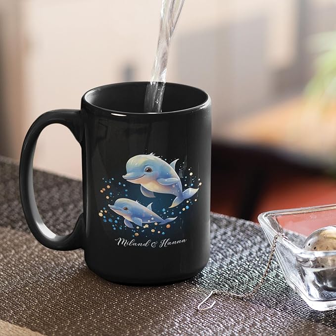 Black mug with blue dolphins and sparkles graphic, custom name, water pouring