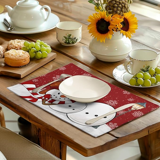 Red snowman Christmas placemat with snowflakes on a dining table, plate centered