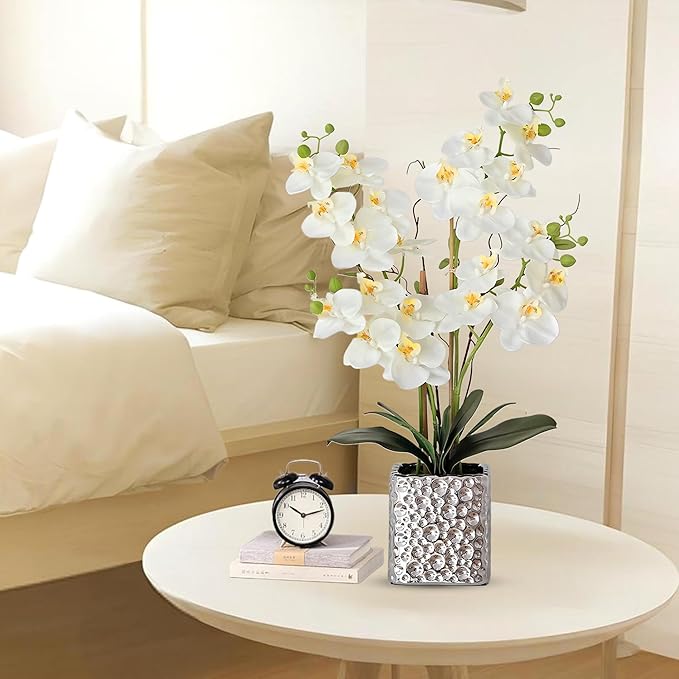 Faux white orchid spray with green buds in a silver textured cube vase