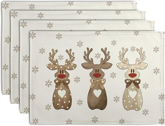 Set of four beige linen placemats with brown reindeer and gray snowflake print