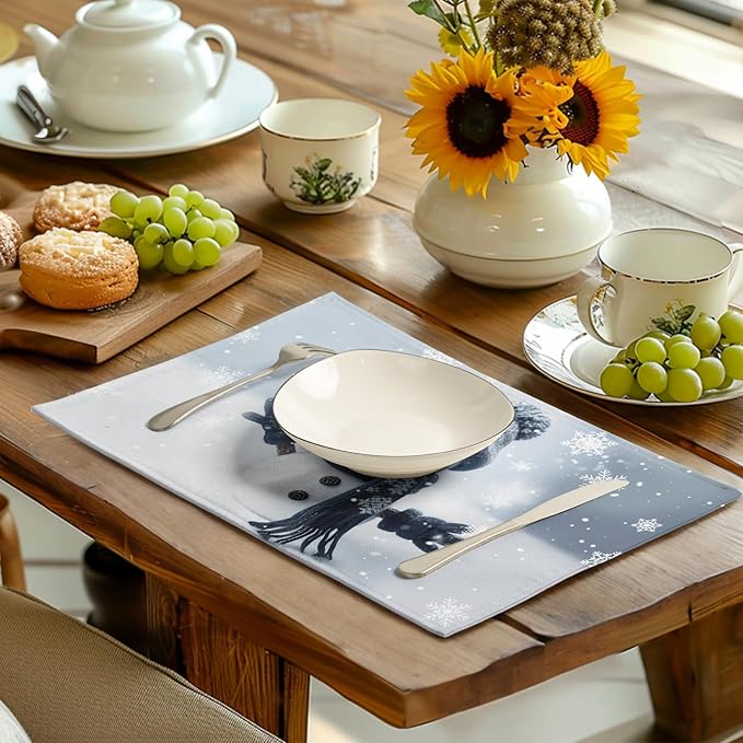 Blue snowman placemats on dining table with dishes and glasses, snowflake print