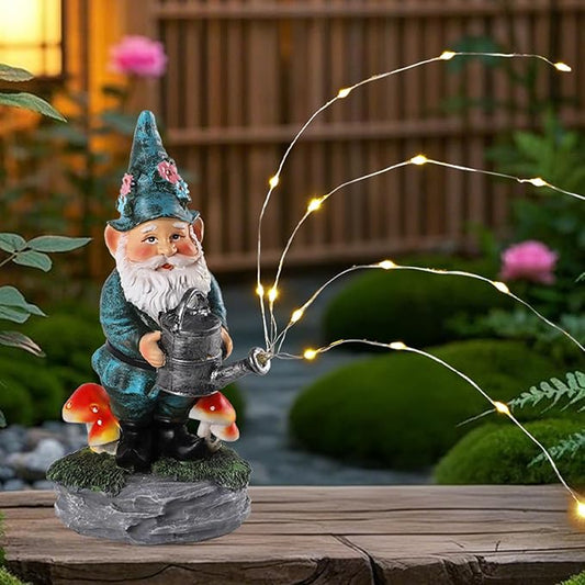 Blue resin gnome statue holding a watering can, lit with warm solar string lights outdoors