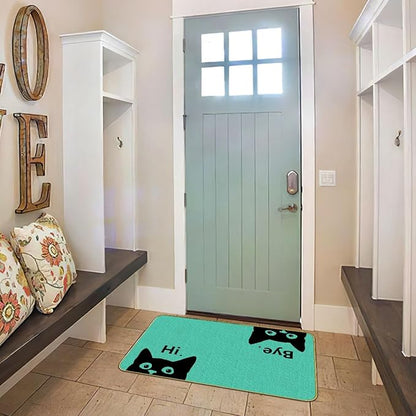 Green cat welcome doormat on indoor entry floor, black cat faces and “Hi”