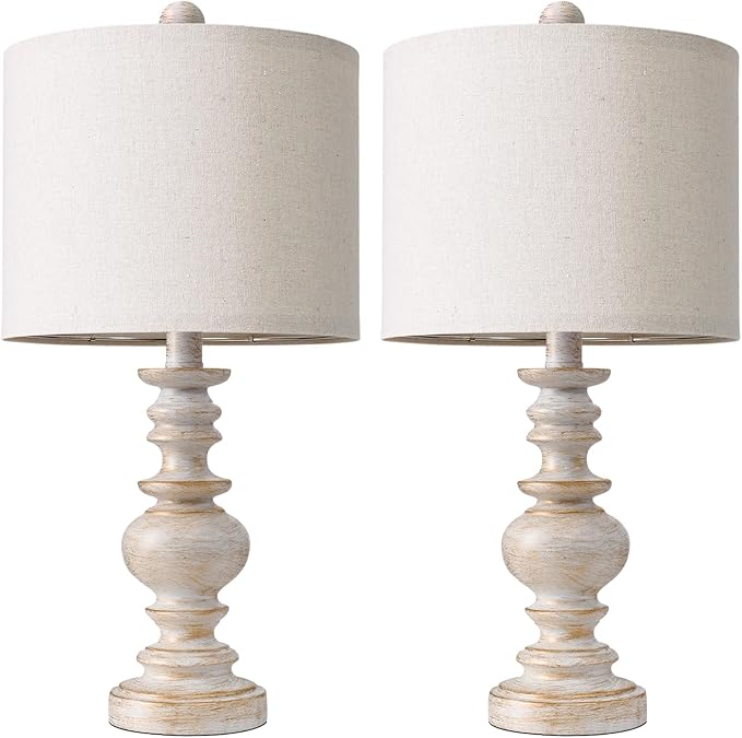 Front view of two table lamps with off-white linen shades and white resin bases