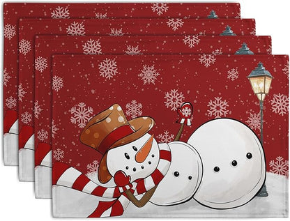 Set of 4 red Christmas placemats with snowman and snowflake design, stacked