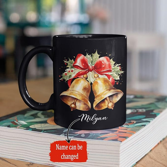 Black ceramic mug with bell and bow print, scripted name Milyan