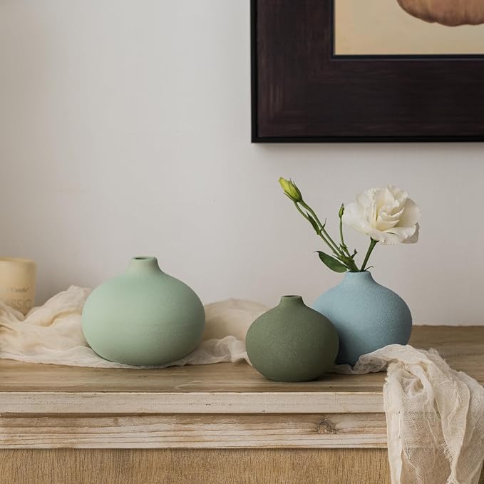 Three mini ceramic bud vases with short neck openings in mint, sage green, and light blue