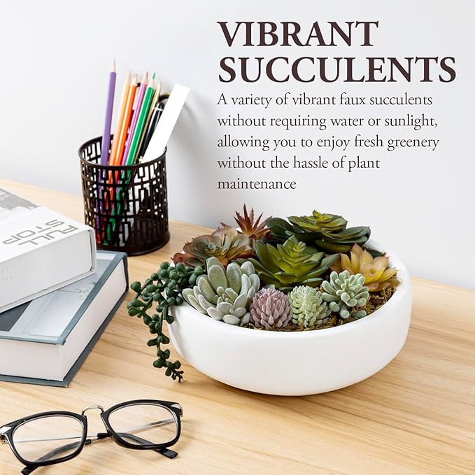 White concrete bowl filled with faux succulents, rosettes, and trailing leaves