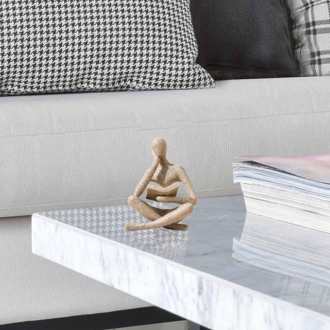 Sandstone-color resin seated reader figurine with open book, cross-legged pose