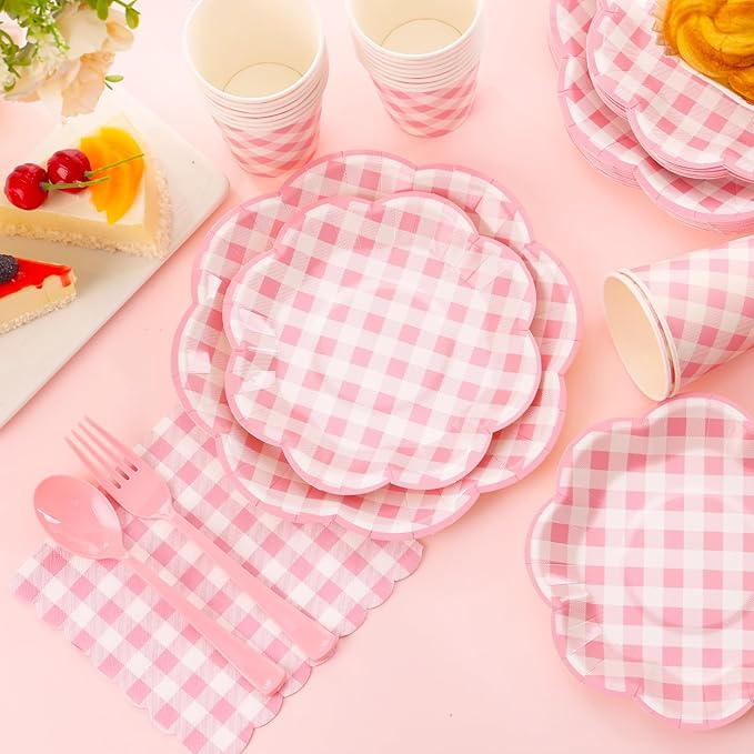 Pink gingham disposable plates and cups set for a picnic, with utensils