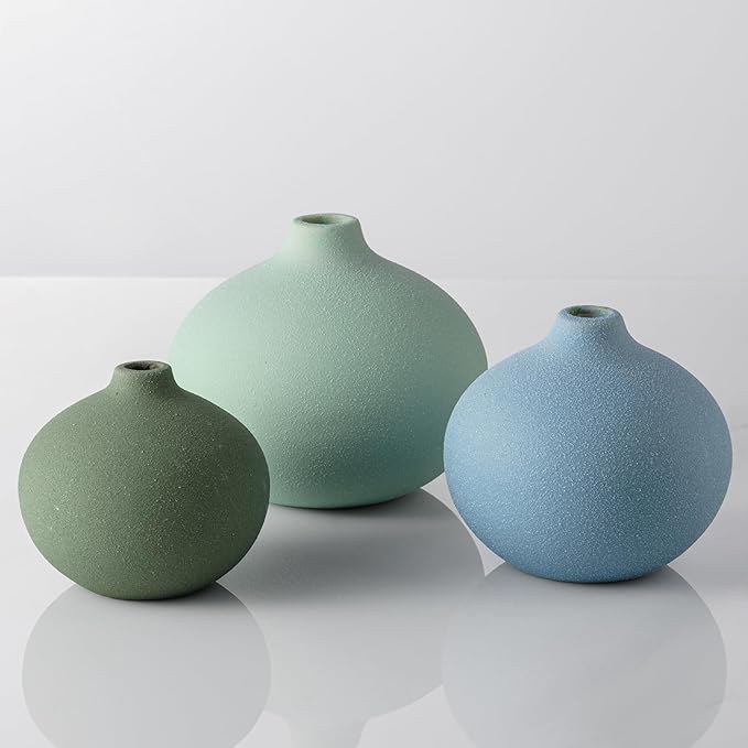 Three mini ceramic bud vases in mint, sage, and light blue with open neck tops