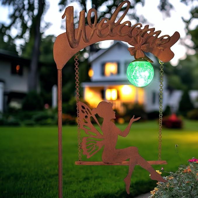 Solar fairy garden light with rust stake, fairy cutout, and glowing green sphere in garden