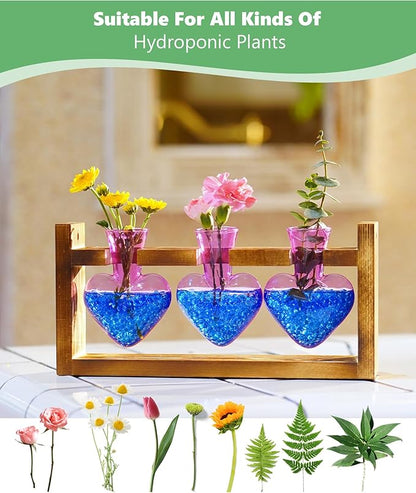 Wood plant propagation stand with three purple heart-shaped glass vases and blue pebble base