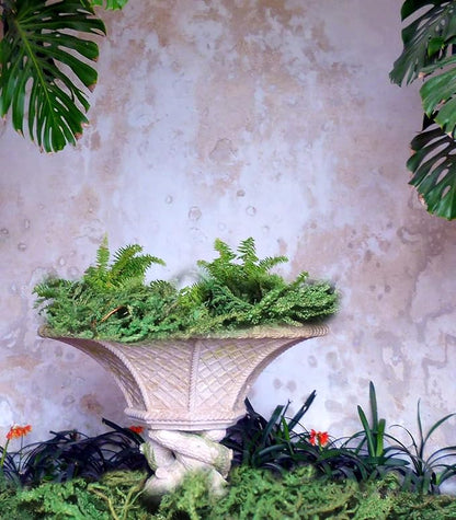 Dark green artificial moss patch in a white textured vase planter