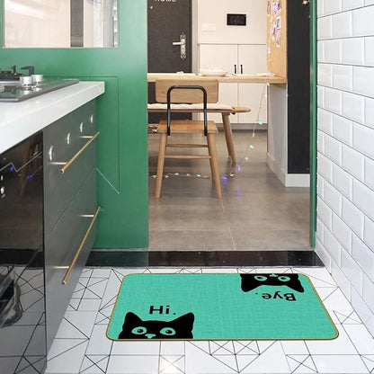 Green cat welcome doormat in kitchen doorway, black cat faces and “Hi” text