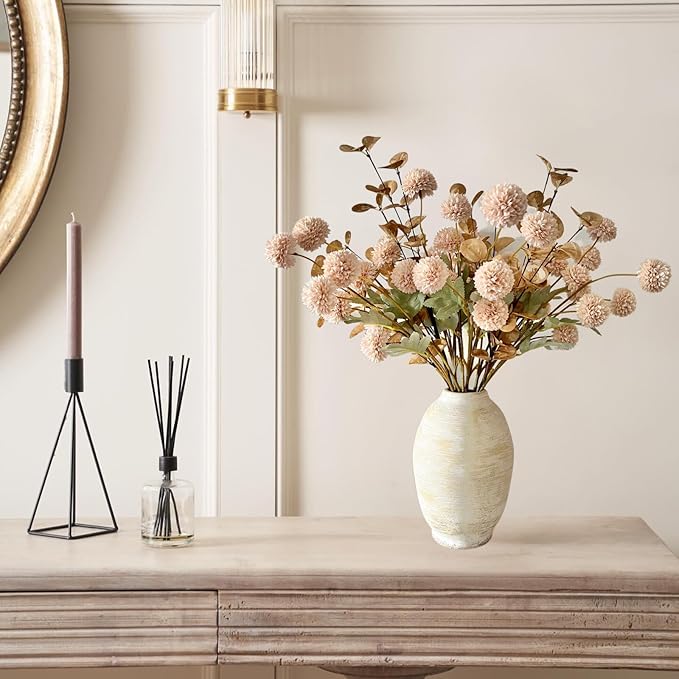 Beige faux pom-pom flower stems with gold eucalyptus accents in a vase