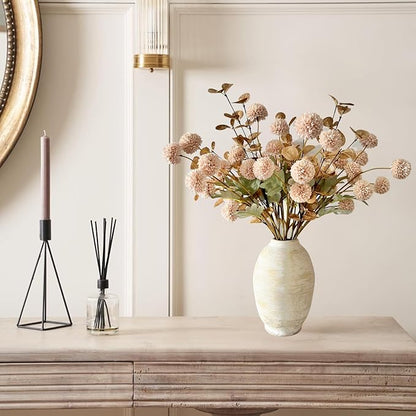 Beige faux pom-pom flower stems with gold eucalyptus accents in a vase