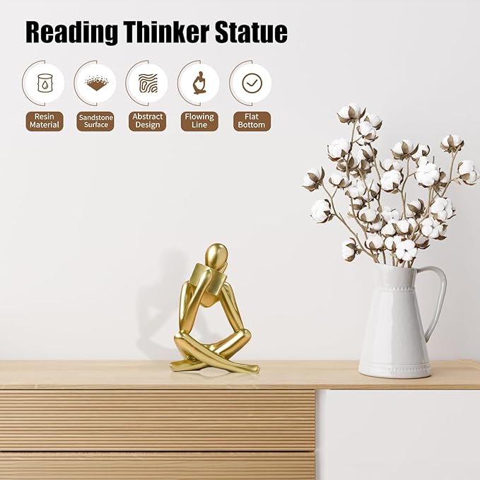 Gold abstract reading thinker resin statue, seated with head bowed and arms on knees.