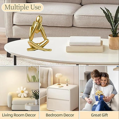 Gold resin reading figurine on coffee table, seated cross-legged