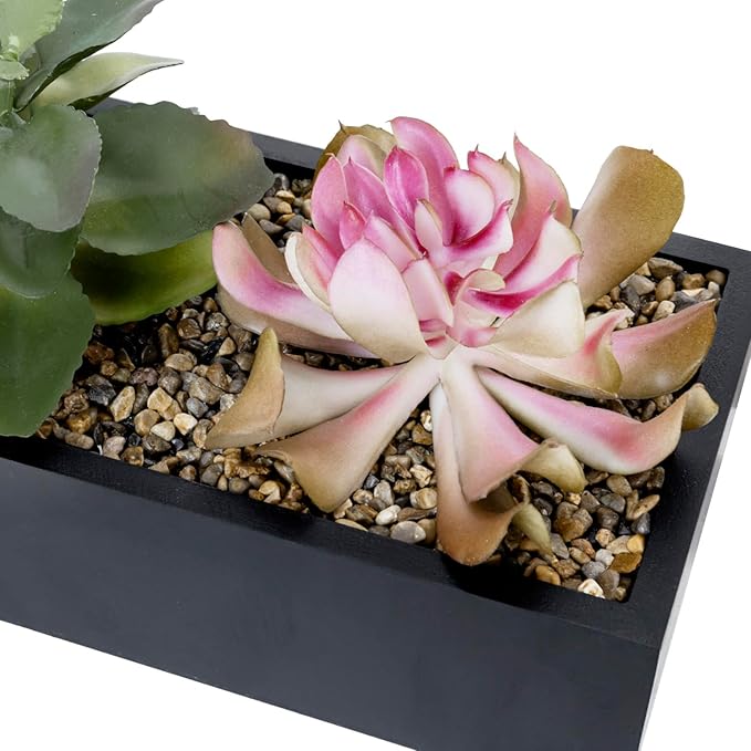 Close-up of pink and green faux succulents in a black rectangular planter