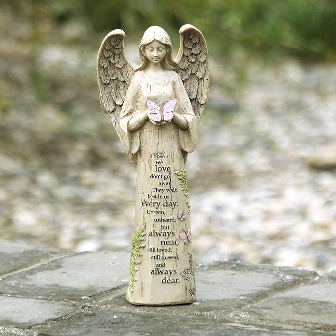 Resin angel figurine with detailed wings, holding a pink butterfly above an engraved poem.