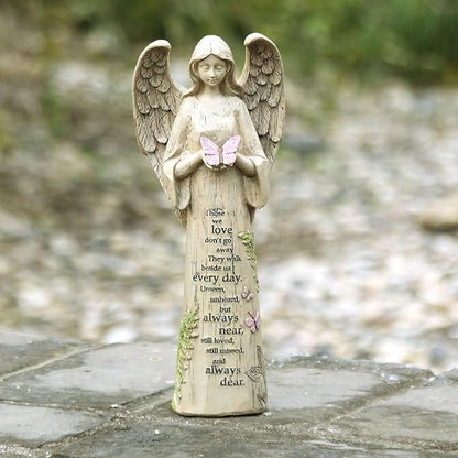 Resin angel figurine with detailed wings, holding a pink butterfly above an engraved poem.