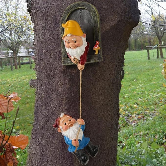 Two peeking tree-face gnome statues, yellow hats, one in red, one in blue, holding rope