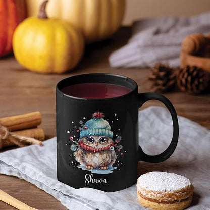 Black ceramic mug with winter owl design, 'Shawn' name, filled with red drink