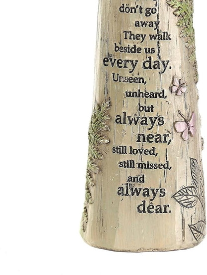 Close-up of the angel figurine's engraved memorial poem and floral butterfly details.