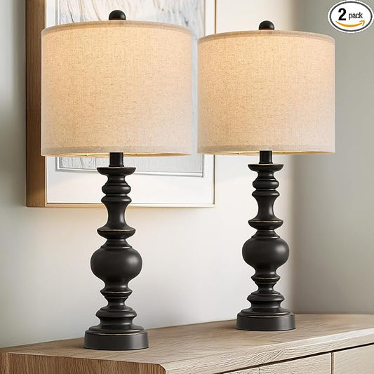 Pair of farmhouse table lamps with dark resin bases and beige linen drum shades