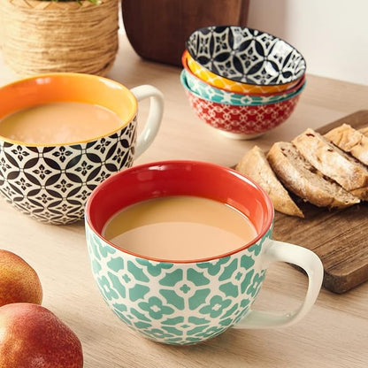 Ceramic coffee mugs on a wooden table: teal floral pattern and red interior, plus matching cups