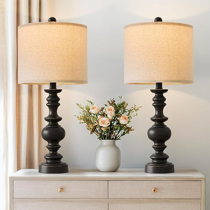 Pair of farmhouse table lamps with black resin bases and beige linen drum shades