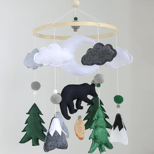 Forest crib mobile with felt moon, clouds, bear, and green pine trees plus hanging gray ornaments