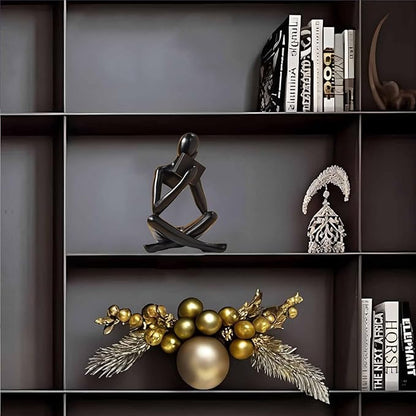 Black resin seated reading abstract figurine, angled view