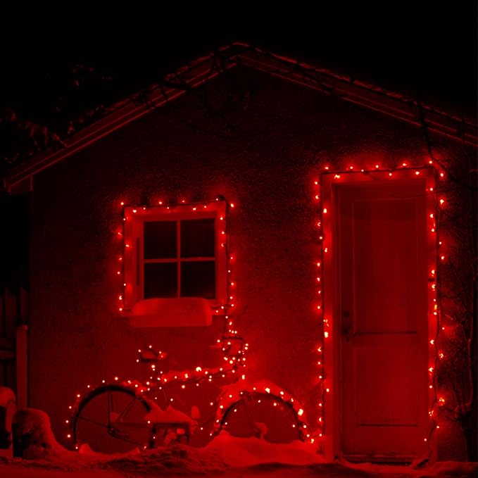 Red mini Christmas string lights outlining windows and doors on a building