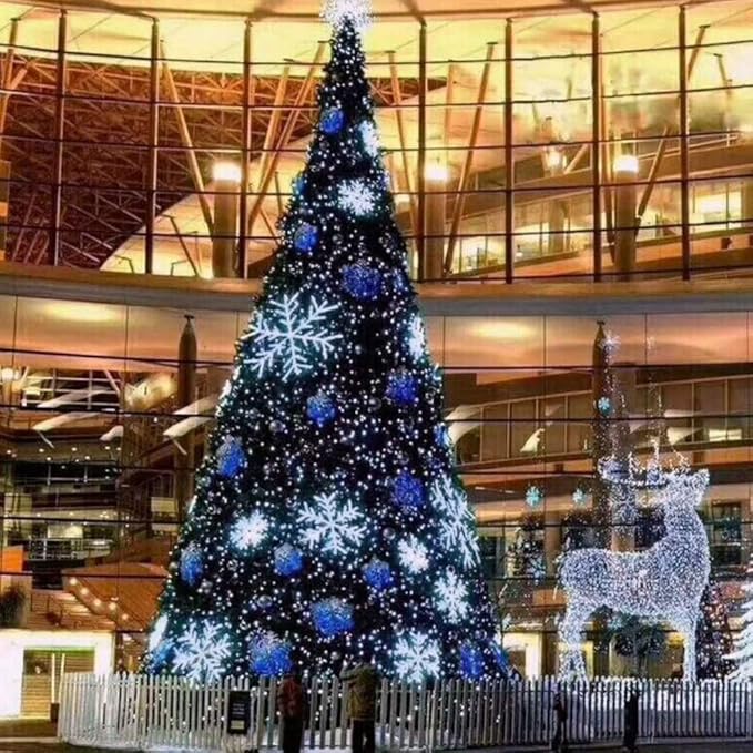 Blue LED mini string lights on a Christmas tree and smaller decorated tree outdoors