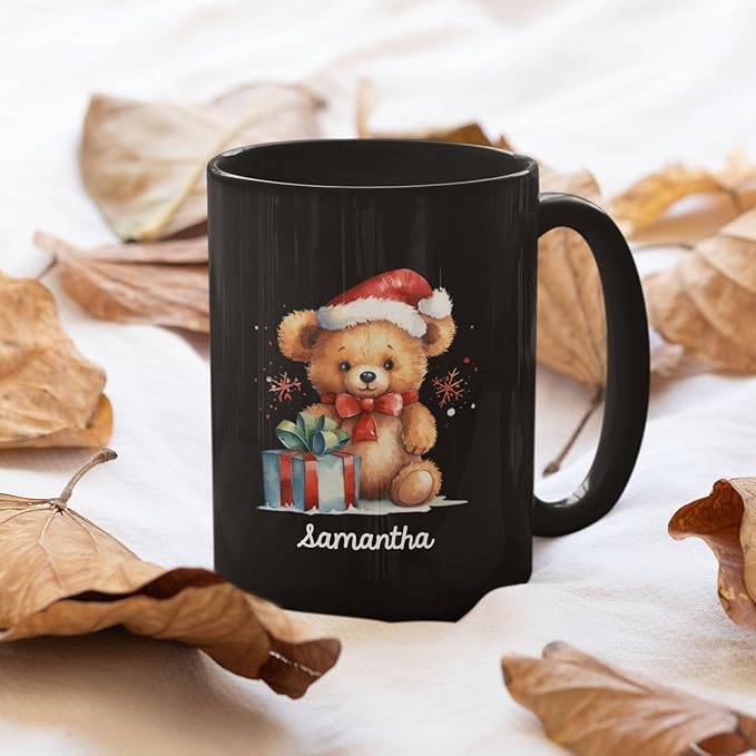 Black mug with teddy bear Santa hat, gift boxes, and name 'samantha' on front