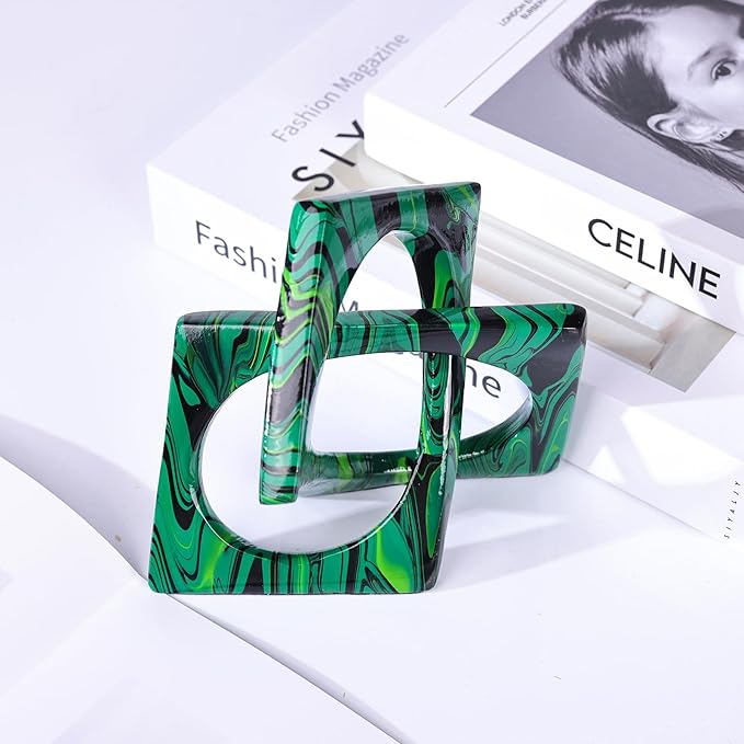 Geometric resin knot sculpture with interlocking open loops and green, black, and teal marbling