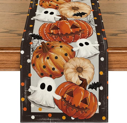 Halloween table runner with dark background, orange pumpkins, white ghosts, spiderwebs