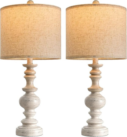 Set of two table lamps with tan linen drum shades and light wood-grain resin pedestal bases