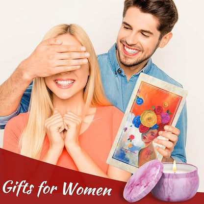 Pink marbled soy candle with flame beside couple holding a floral gift card