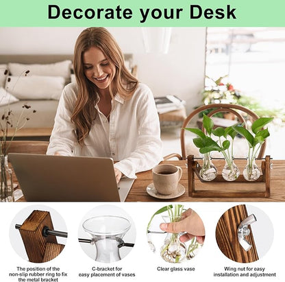 3 clear glass bulb vases with greenery on a brown wood and metal desk stand