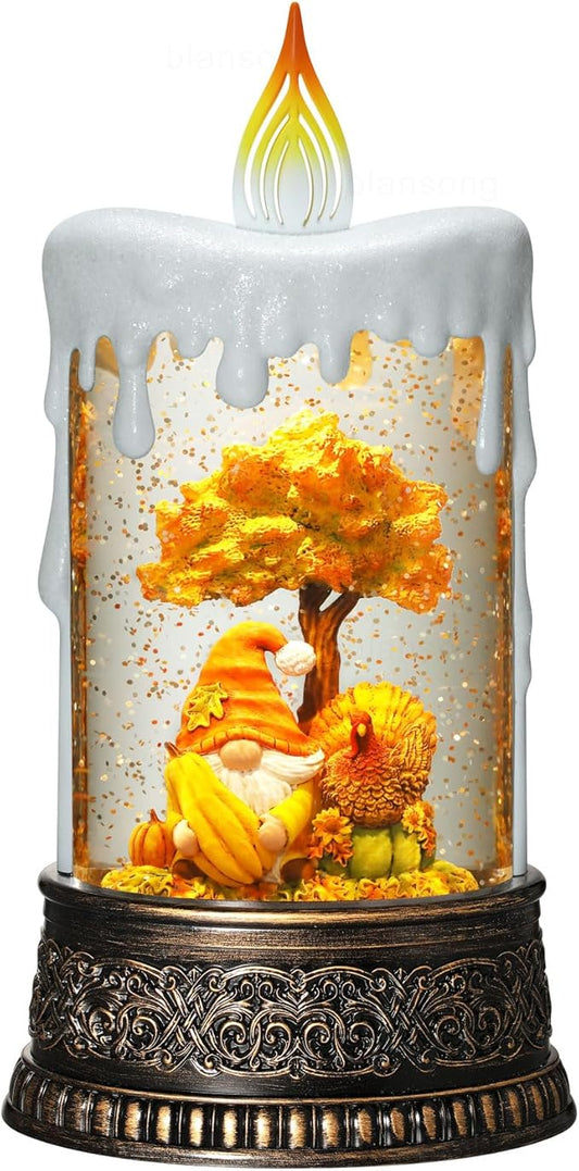Autumn snow globe candle with gnome, turkey, pumpkins and glowing flame, in glass