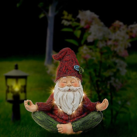 Yoga gnome garden statue with closed eyes, red hat and white beard, seated cross-legged