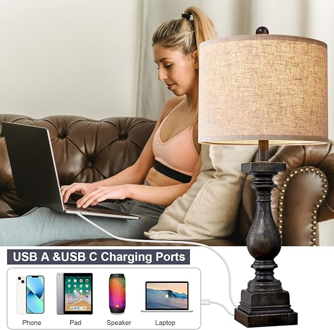 Table lamp featuring USB charging ports with fabric shade and dark resin base