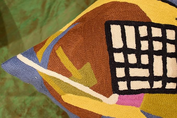 Abstract embroidered pillow cover closeup with brown, yellow, and black grid